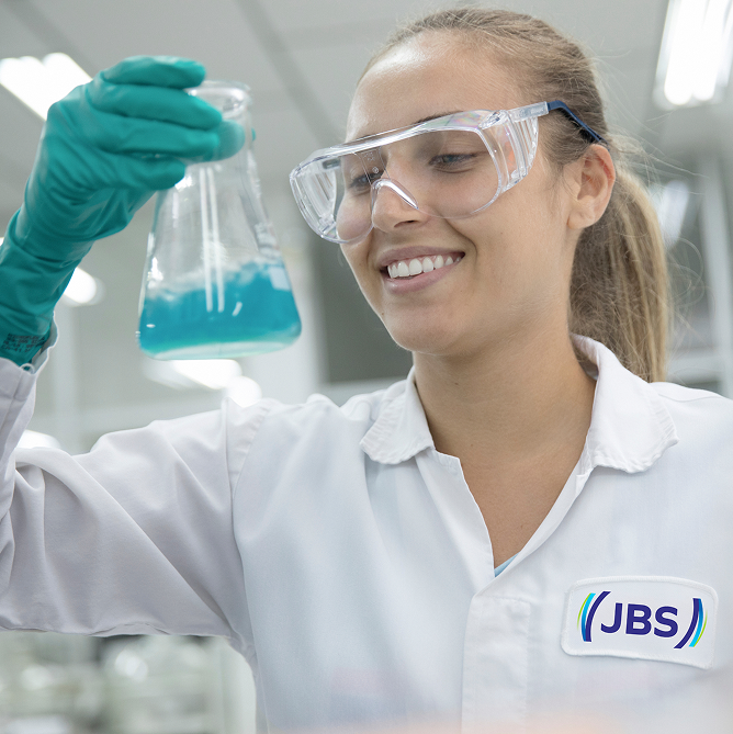 JBS team members near a food-production facility